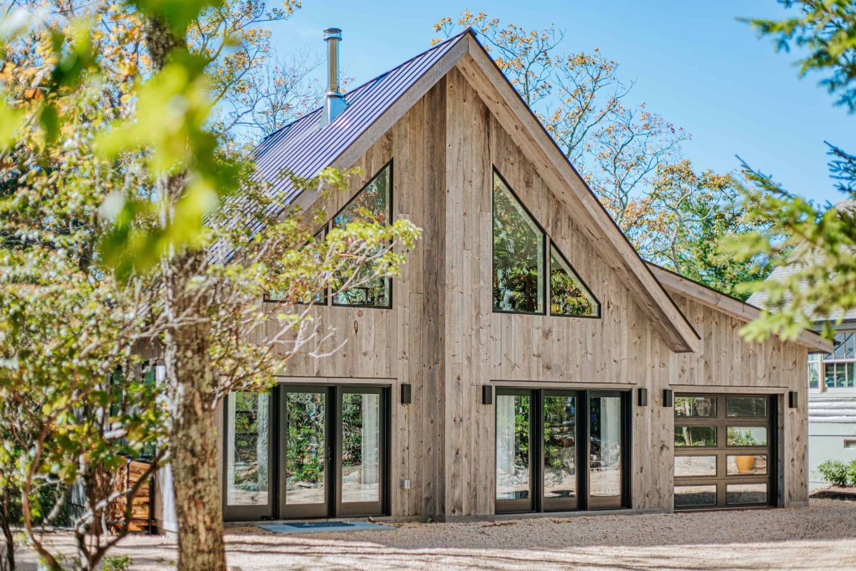 exterior of a natural wood finished cabin with a modern design in the daytime
