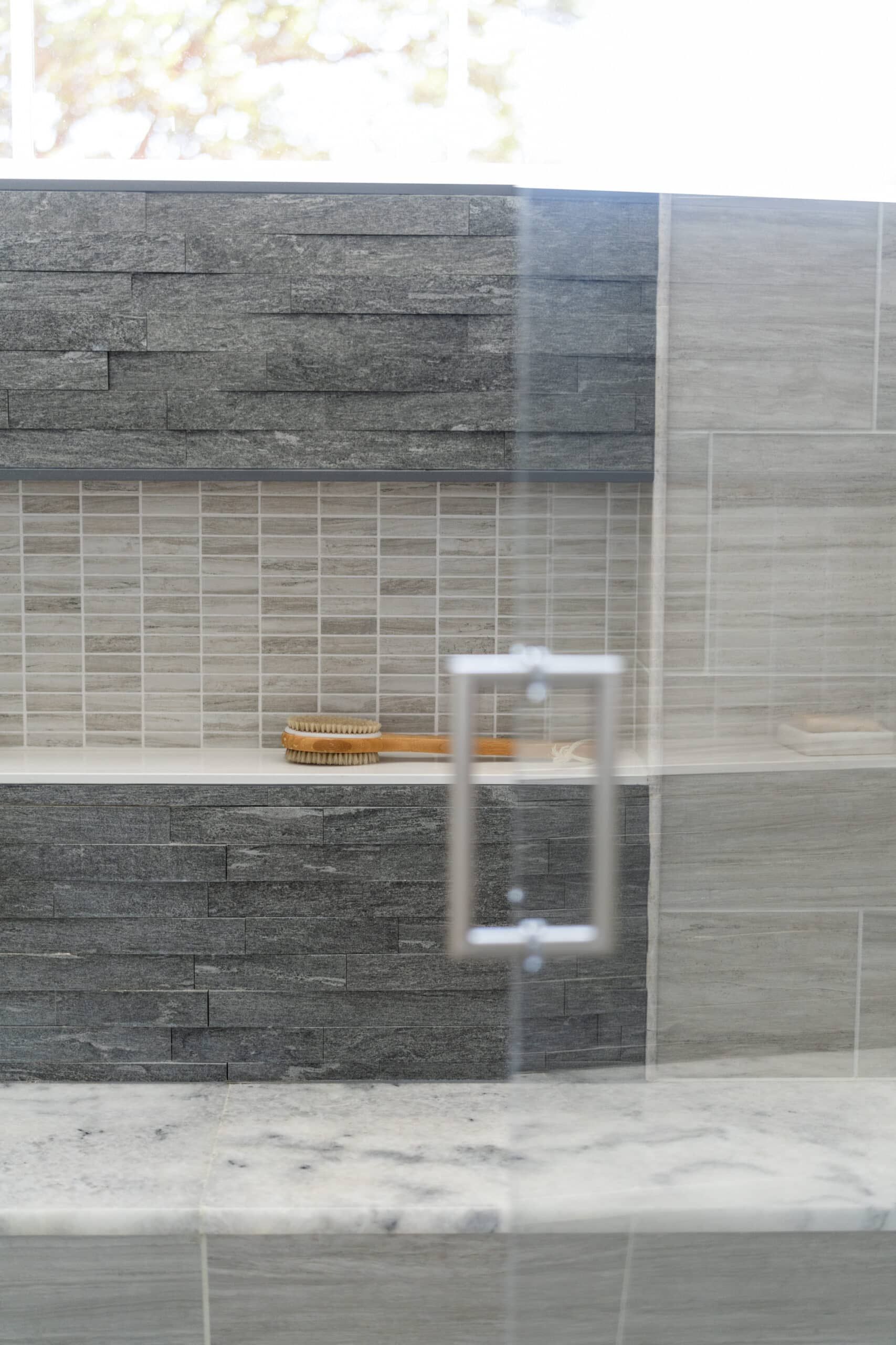 detail view of the inside of a large shower as seen through its clear glass door