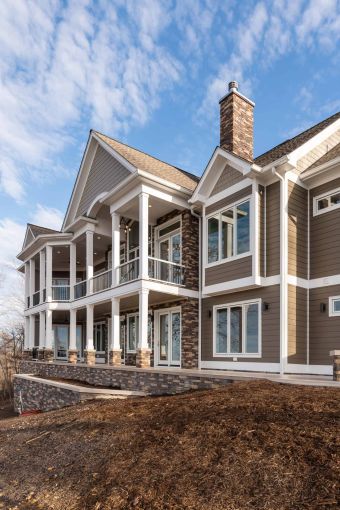 house exterior, brick facia with white columns, door, and window trim as seen from an angle