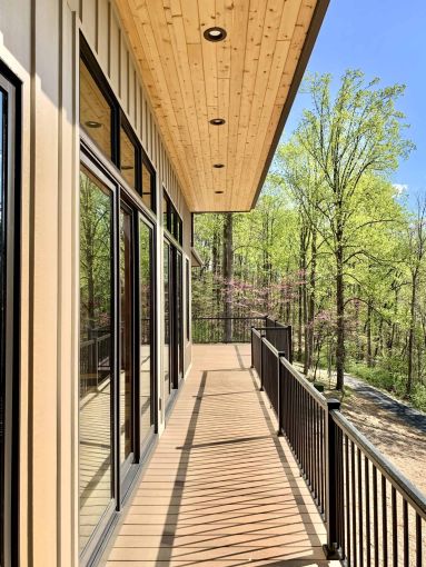close view of a home balcony with a wood roof and recessed lighting