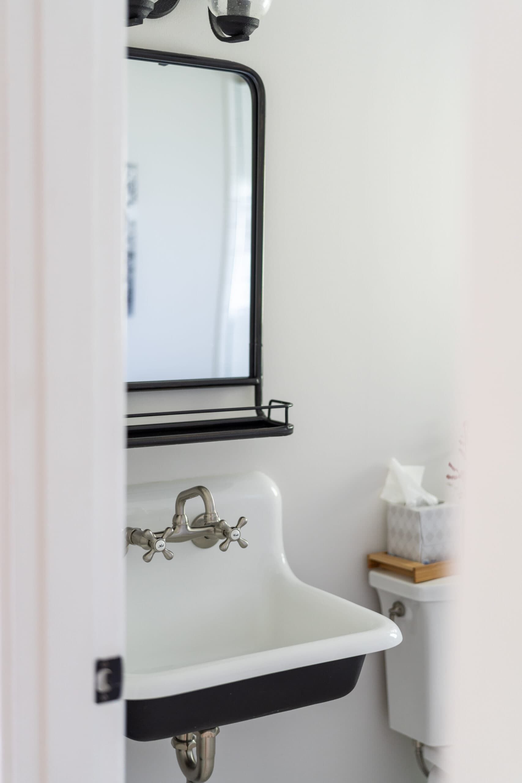 antique two-town black and white sink basin and mirror